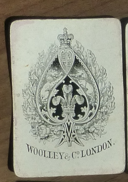 A c.1880s pack of standard playing cards by WOOLLEY & Co. 51 cards. Missing 4 of Spades. Condition: well used and some staining.